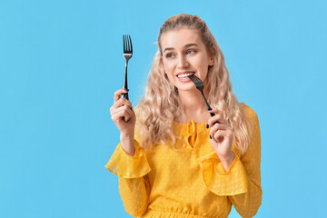 Sticker - Beautiful young woman with forks on color background