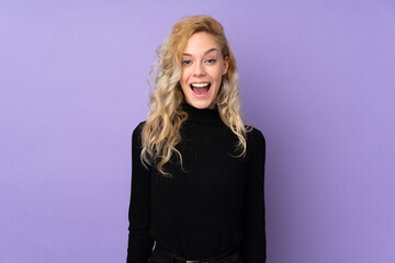 Canvas Print - Young blonde woman isolated on purple background with surprise facial expression