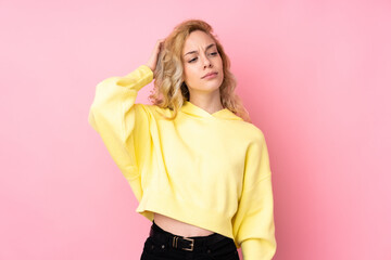 Poster - Young blonde woman wearing a sweatshirt isolated on pink background having doubts while scratching head