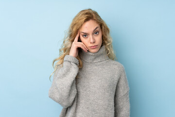 Poster - Young blonde woman wearing a sweater isolated on blue background thinking an idea