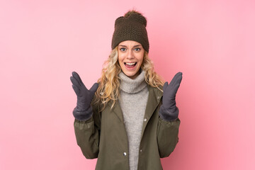 Canvas Print - Young girl with winter hat isolated on pink background with surprise facial expression