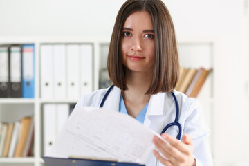 Wall Mural - Beautiful smiling female doctor hold clipboard pad