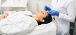 Cleansing face. Brunette woman with eyes closed while mechanical cleansing facial skin from defect and remove blackhead