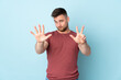 © luismolinero - Russian handsome man over isolated background counting eight with fingers