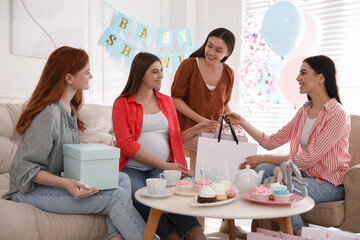 Canvas Print - Happy pregnant woman spending time with friends at baby shower party