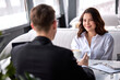 © Roman - two business partners are talking over cup of coffee, sitting in cafe or restaurant