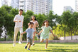 © Blue Jean Images - Happy young family playing in park