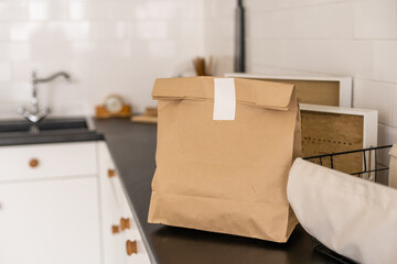 Paper packages with groceries on kitchen table