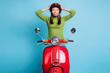 Poster - Portrait of positive pretty person sit on bike arms on head unbelievable reaction isolated on blue color background