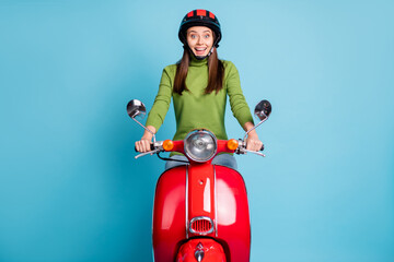 Sticker - Portrait of astonished nice charming lady driving bike open mouth smile isolated on blue color background