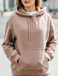 © andrew_shots - Fasion blonde woman in brown oversize hoodie, glasses and blue jeans, mockup for logo or branding design