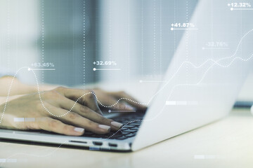 Multi exposure of stats data illustration with hands typing on computer keyboard on background, computing and analytics concept