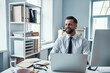 © gstockstudio - Happy young man in shirt and tie working using computer and smiling while sitting in the office