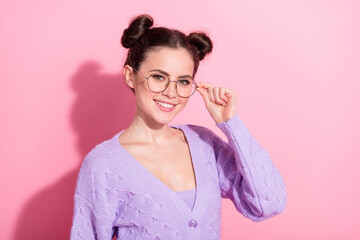 Poster - Photo portrait of pretty cute woman with top knot hairstyle smiling in casual outfit isolated on pastel pink color background