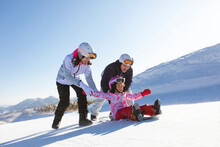 Happy Young Family Relaxing In Ski Resort