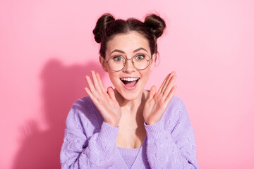 Poster - Photo portrait of cheerful happy girl in spectacles smiling amazed gesturing hands isolated on pastel pink color background