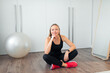 © shapovalphoto - woman doing fitness exercise at home, sit on floor