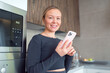 © shapovalphoto - woman in the kitchen with a phone