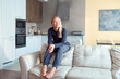 © shapovalphoto - woman sitting on sofa at home