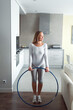 © shapovalphoto - young woman with a hoop at home