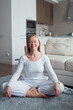 © shapovalphoto - woman in yoga meditation pose at home, me time and wellness concept