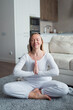© shapovalphoto - woman in yoga meditation pose at home, me time and wellness concept