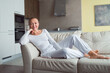 © shapovalphoto - Young woman lay on sofa at home, wear comfortable home suit