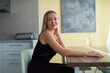 © shapovalphoto - woman sitting at table at home with wine glass
