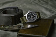 Vintage military watch with nato strap and tactical knife on army green background, Classic timepiece mechanical wristwatch, Military men fashion and accessories.
