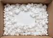 © Adrian - A cardboard box with packing styro foam pellets top view