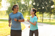 © Blue Jean Images - Happy mature couple running in park
