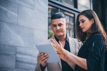 Wall Mural - professional business worker person, woman meeting businessman in the morning, colleague corporate manager team talking outside office on the street in city building background