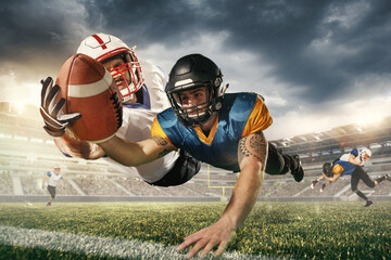 American football players in fight for goal at stadium in flashlights. Professional sportsman during game playing in action and motion.