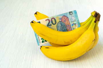 Wall Mural - Bunch of ripe banana with Euro currency