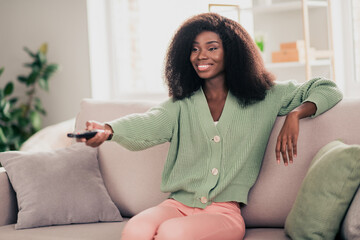 Sticker - Photo of young cheerful afro woman happy positive smile switch channel watch film rest weekend sit couch home