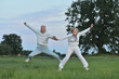 © aletia2011 - happy senior couple jumping  in the park