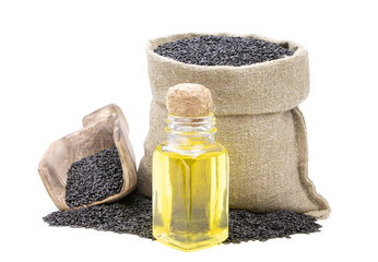 Black sesame essential oil. Glass bottle of black sesame oil. Black sesamei n a sack of isolated on a white background. Black sesame in a burlap sack. Healthy food.Vegan food. Copy space