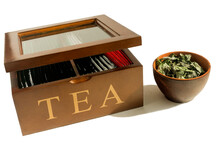 Wooden Container For Storing Tea Bags And A Bowl With Dried Mint.