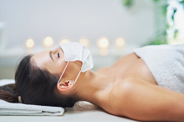 Wall Mural - Adult woman in mask during relaxing massage in spa