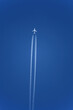 Jet trail from airplane travelling over clear blue sky