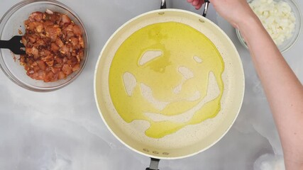 Wall Mural - Olive oil on frying pan, close up video, flat lay, woman hands. Step by step sour cream Sour cream chicken paprika recipe