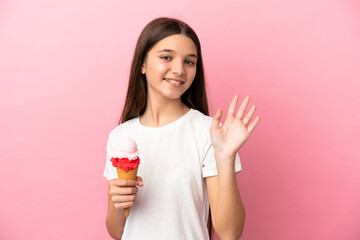 Sticker - Little girl with a cornet ice cream over isolated pink background saluting with hand with happy expression