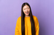 © luismolinero - Young Chinese girl over isolated purple background shouting to the front with mouth wide open