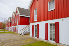 Red Wooden Houses In Sweden. Swedish Houses On A Street. Vacation In Sweden