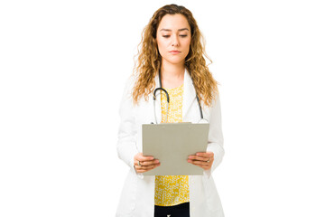 Wall Mural - Beautiful doctor filling out a patient's medical form