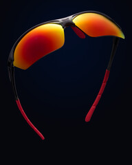 A pair of sunglasses on a black background.