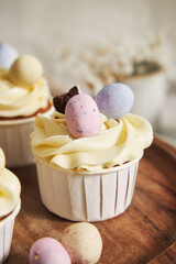 Canvas Print - Delicious carrot cupcakes with whipped cream and topping from candies in eggs shape for Easter