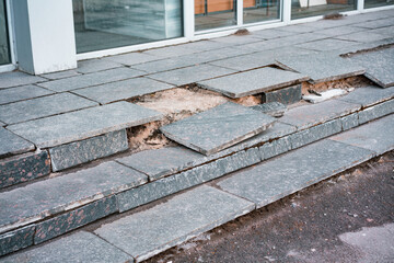 Outdoor broken tile stairs near the building. Destroyed steps. Ruins of crushed staircase. Bad. Urban. City. Abandoned. Crumbling. Concrete. Repair