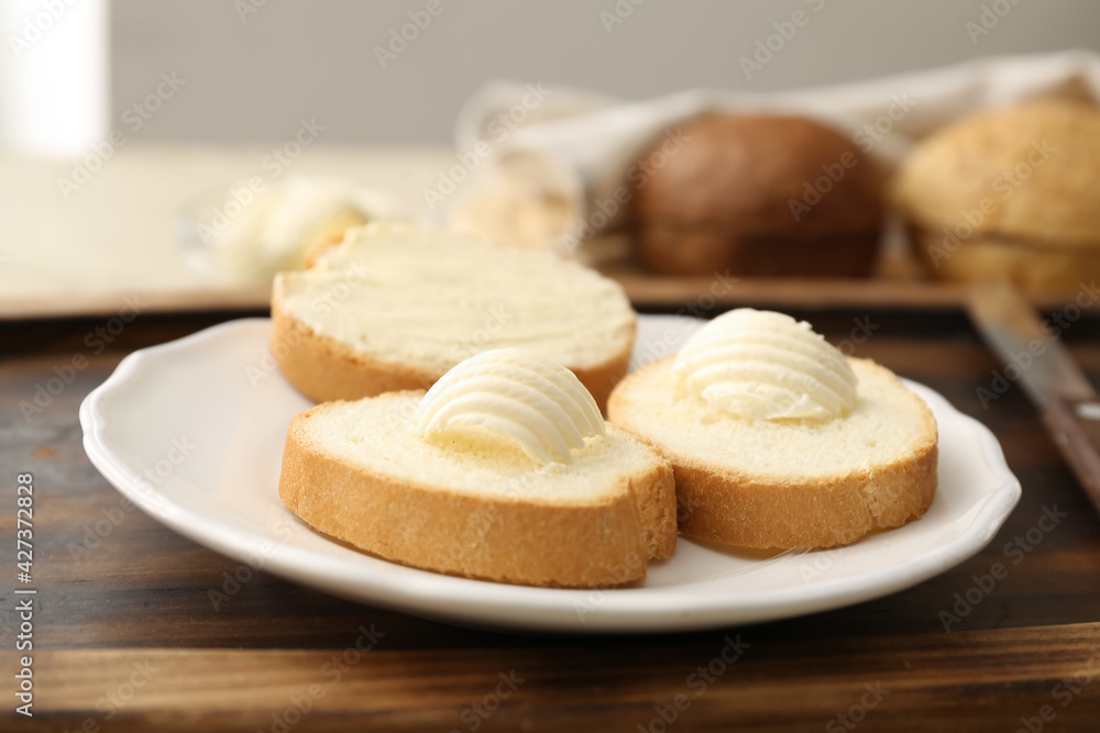 Slices of fresh bread and butter on grunge background