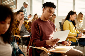 African American college student learning during class in the classroom.